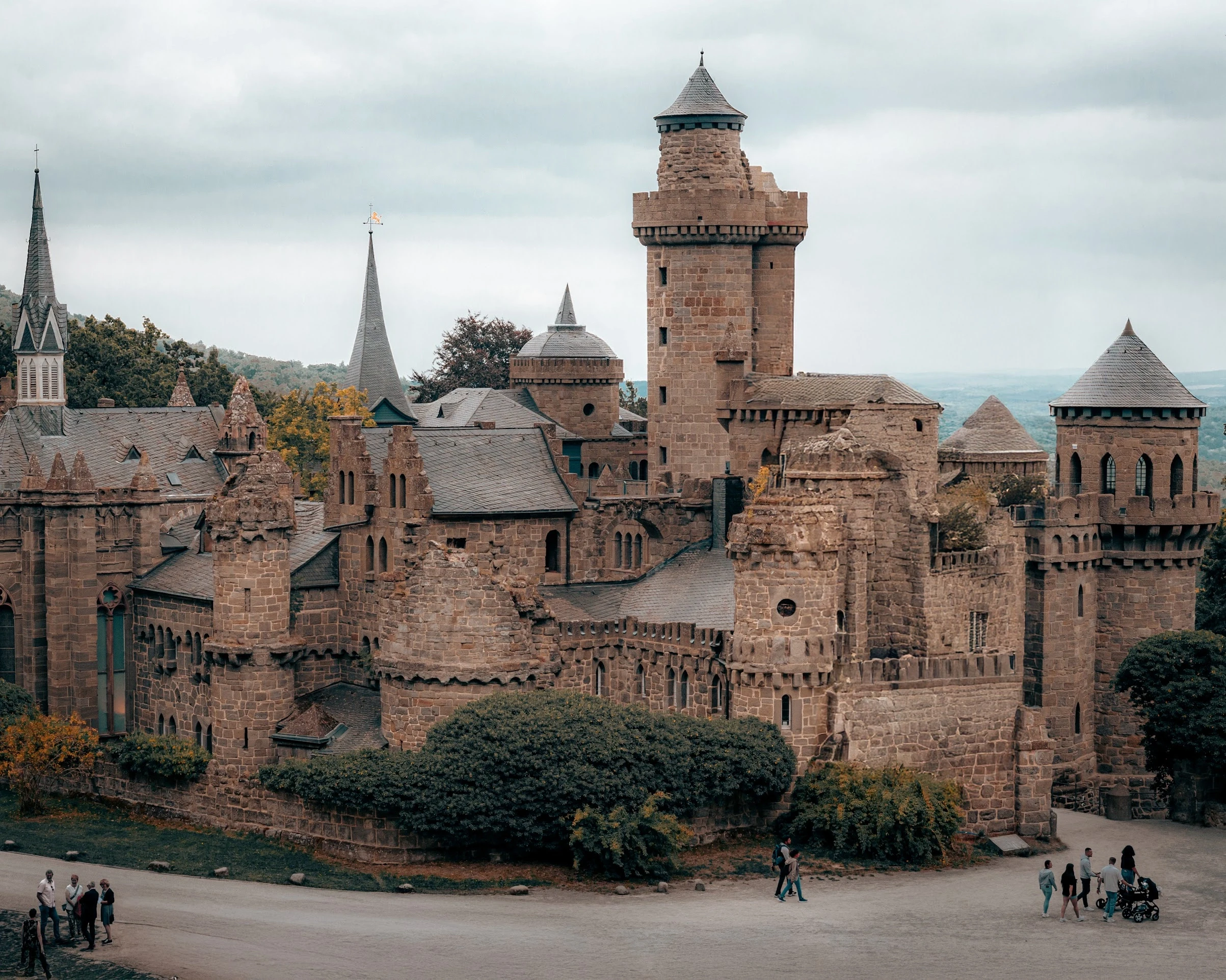 Stone towers and fortified walls beneath a soft, overcast sky.