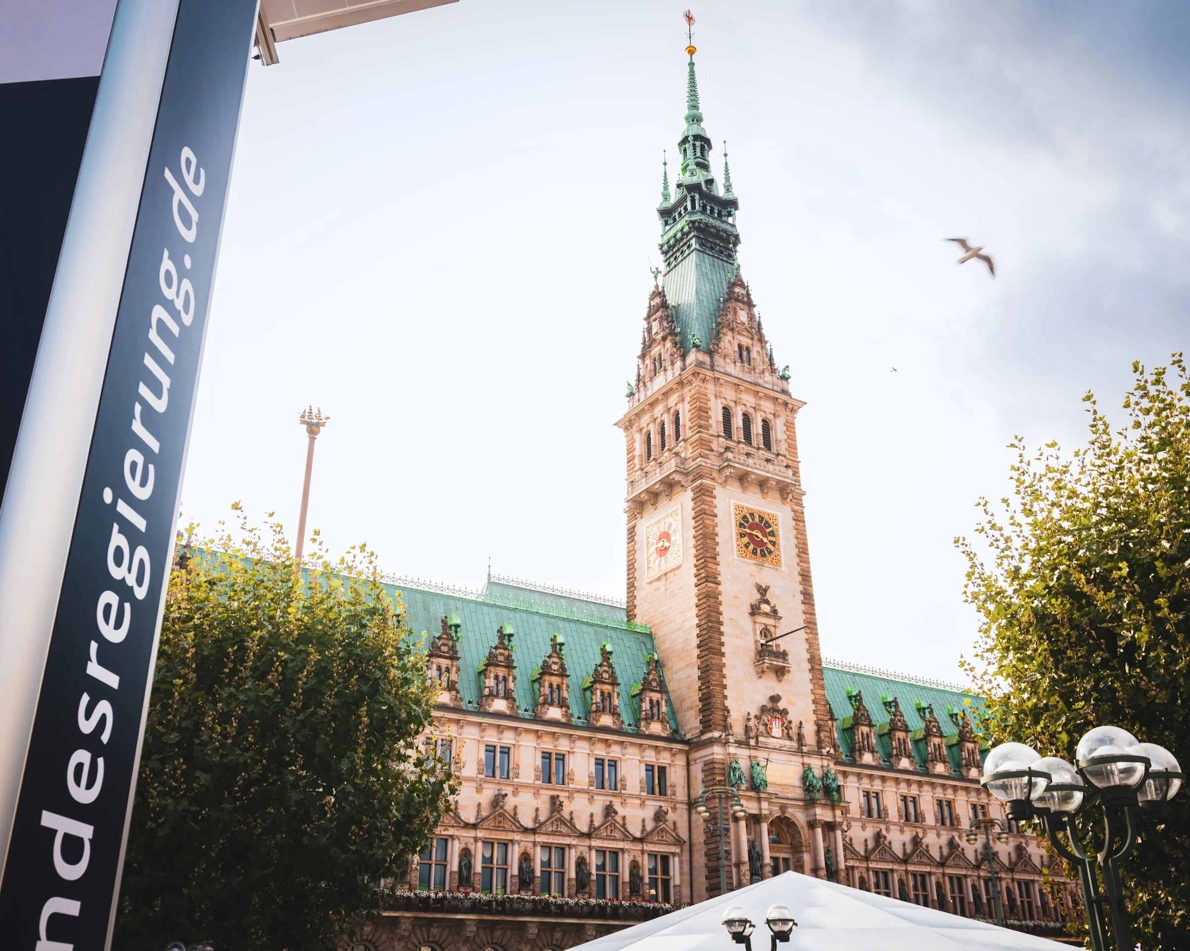 Hamburg's ornate town hall tower seen from the square below.